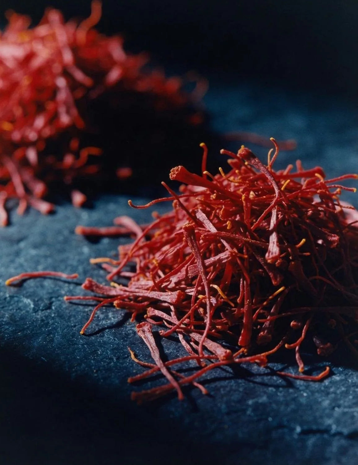 Saffron threads on indigo stone